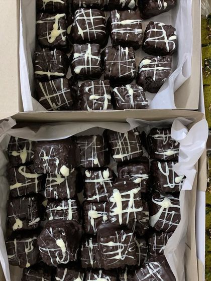 Boxes of my eggless Double Chocolate Brownies, a perfect sweet addition to a catered dinner party.