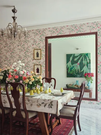 A view of the dining table, reflecting a large painting in the adjacent room. This layering of spaces and art is a key element of our design, creating depth and a sense of discovery.