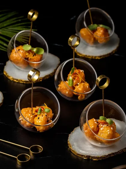 Big on crunch, bold on flavour. Our Dynamite Prawns are coated in a crispy tempura batter and tossed in a creamy, spicy mayo, served in elegant glass spheres.
