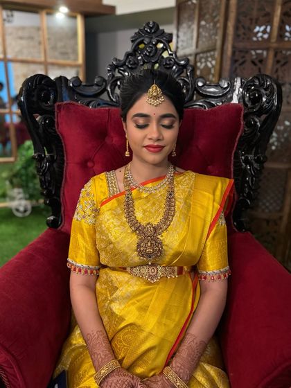 A close-up of the baby shower makeup with eyes closed, showing the soft, shimmery eyeshadow that balances the bold lip.