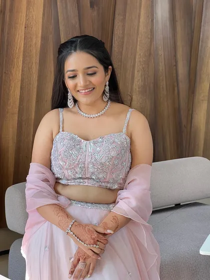 A beautiful, soft glam look in a pastel pink lehenga.