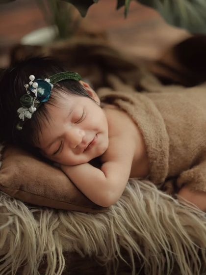 A close-up of a sleeping newborn, showing their delicate features and peaceful expression. These are the details you'll want to remember forever.