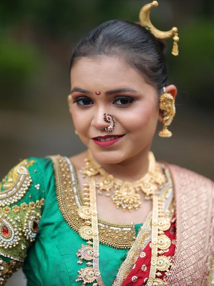 A close-up of the bridal makeup and jewellery, including the distinctive Maharashtrian nath and ear cuffs (kaan vel).
