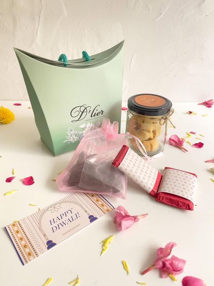 Another version of our mini Diwali hamper, presented in a chic mint green pillow box, perfect for smaller, elegant gifts.
