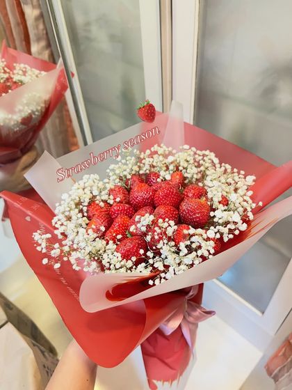 The perfect gift for strawberry season. This bouquet, wrapped in bold red, is overflowing with fresh strawberries and accented with baby's breath, making it a simple yet stunning gesture.