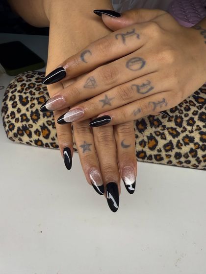A modern, graphic French manicure. This design uses sharp black lines and a hint of glitter for an edgy and artistic look.