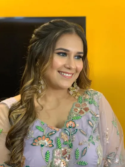 A happy smile from the Roka bride, showcasing her glowing makeup and soft curls.
