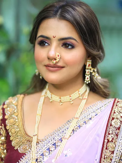 A close-up on the makeup, featuring a soft plum eyeshadow and a traditional nath.