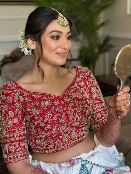 Another angle of the bride admiring her look. The makeup features eyes that tell a story and a glow that won't dim, perfectly capturing her naive yet enchanting vibe.