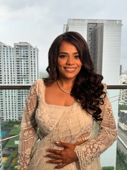 Another beautiful shot of the sister of the groom. The soft curls and dewy makeup create a look that is both modern and timelessly beautiful.