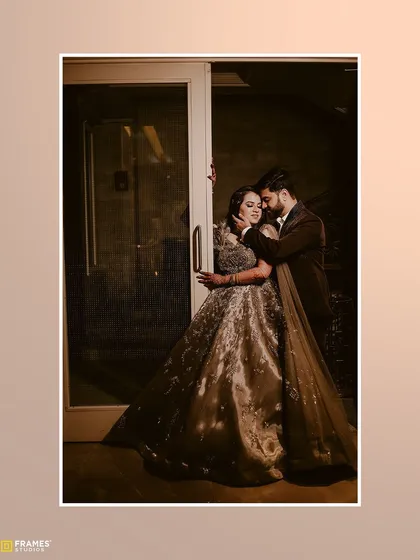 The groom in his custom brown three-piece suit, sharing a quiet moment with his bride. The suit was designed to complement the tones of her beautiful gown.