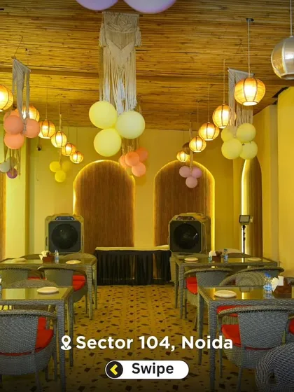 The outdoor dining area set up for an evening party, with string lights and balloons creating a festive mood.
