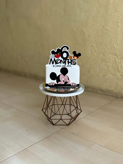 A cute Mickey Mouse cake for a half-birthday celebration. It's a great way to mark the six-month milestone.