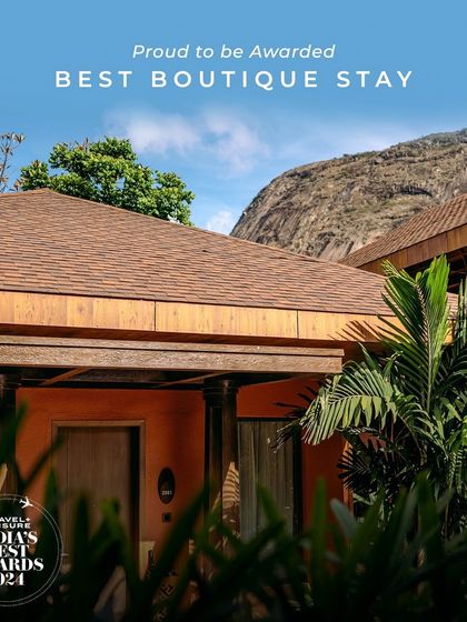 We are proud to be recognized as a Best Boutique Stay, reflected in the unique design and serene setting of our accommodations, seen here against the backdrop of Nandi Hills.