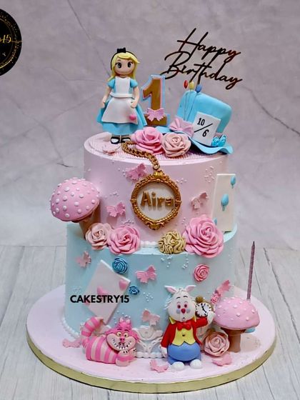 We went down the rabbit hole for this "Alice in Wonderland" themed first birthday cake. This two-tier choco-chip cake is full of whimsical details, including the White Rabbit, Cheshire Cat, and Mad Hatter's hat.