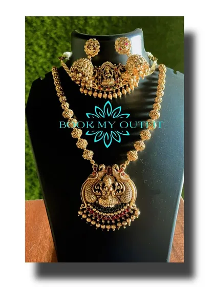 This is a classic temple jewelry set that I offer for rent. It features a traditional goddess motif on both the choker and the longer necklace, perfect for pairing with a silk saree for a traditional function.