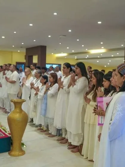 A moment of quiet reverence as participants stand in prayer during a session. The atmosphere in our Kashmir retreats is one of deep peace and spiritual focus.