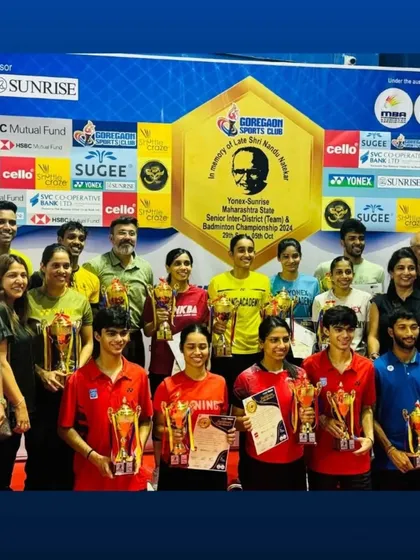 A group photo of all the champions on the final day of the badminton tournament, celebrating their skill and sportsmanship.