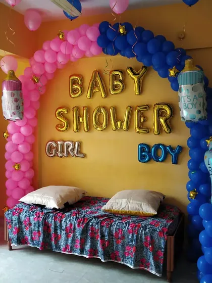 A classic 'Boy or Girl' baby shower theme. The balloon arch is split between pink and blue, with matching 'It's a Boy' and 'It's a Girl' foil balloons.