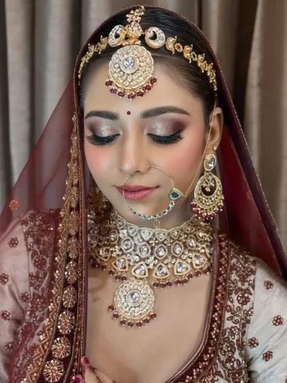 A beautiful close-up focusing on the bride's shimmery eye makeup and perfectly blended base, creating a soft yet glamorous effect.