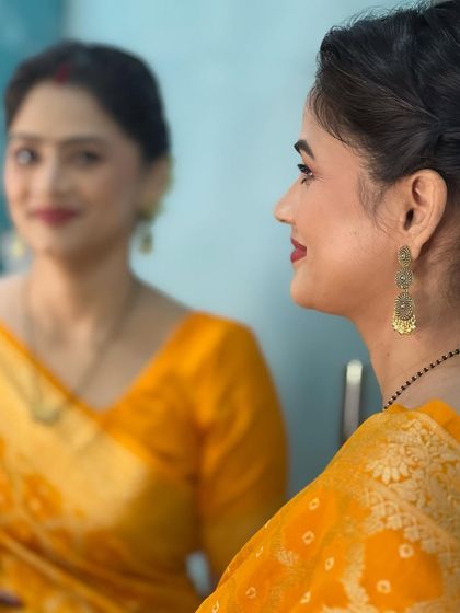 A mirror reflection shot, capturing her beautiful smile and the soft, glowing makeup.