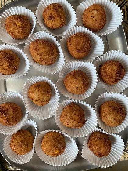 Corn & Cheese Balls served in individual paper cups for easy and hygienic party snacking.