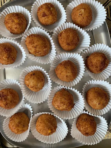 Corn and cheese balls individually placed in paper cups.