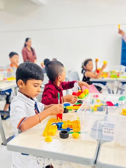 Young students at The School for Global Minds are fully engaged in our LEGO Education program, building and exploring with colorful bricks.
