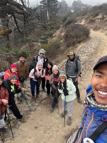 A selfie with our happy group and our amazing local guide on the Sandakphu trail. The guides are a crucial part of our trekking family.