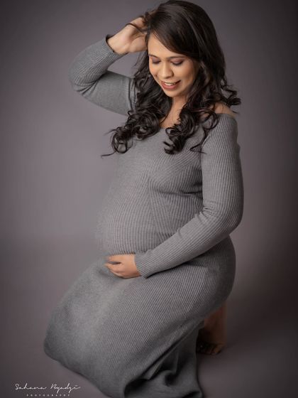 A beautiful, gentle pose on the floor. This shot highlights the mom-to-be's gorgeous hair and serene expression, creating a soft and intimate portrait.