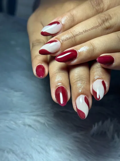 The contrast between the rich burgundy and the soft nude creates a striking and artistic look.