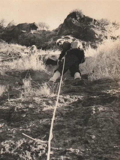 An old photo of a climber on a rope. We are proud to continue the tradition of adventure that was started by pioneers decades ago.