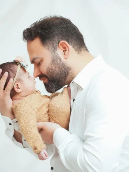 The bond between a father and his newborn is incredibly precious. I make sure to capture these quiet, tender moments during our family portrait sessions.