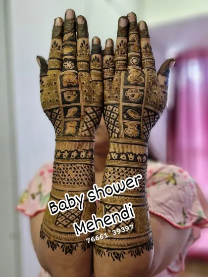 A fun and full-coverage baby shower mehendi. The design is filled with cute cartoon baby faces and checkerboard patterns, perfect for a joyful celebration.
