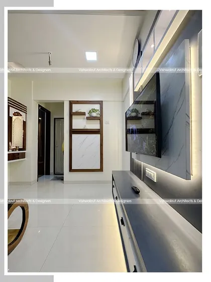 A view of the living room in a 1BHK apartment, showing how the TV unit, foldable dining table, and dressing table are all arranged to create a multi-functional yet uncluttered space.