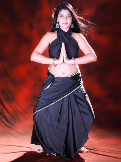 A 'namaste' pose that brings a sense of calm and tradition to the modern saree look. The contrast creates a very interesting image.