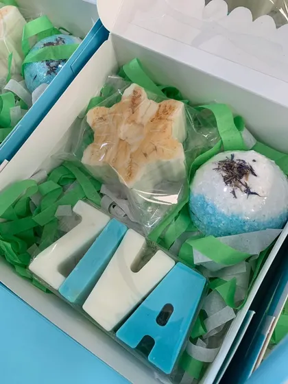 A 'Frozen' themed return gift box, featuring a personalized 'Ziva' name soap in icy blue and white, along with other themed soaps.