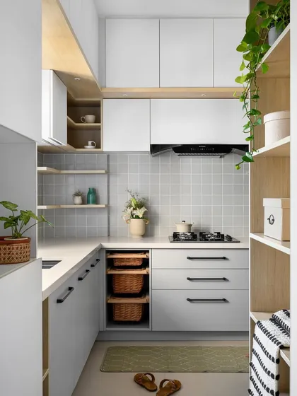Our 'Mellow Menlo' kitchen is soothing and cottagish. We expanded the compact space to accommodate ample storage, including open shelves and pull-out baskets, all within a subtle monochrome palette.