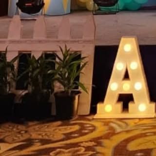 A close-up of a light-up marquee letter "A". These letters are a great way to add a personalized and decorative element to any party space.