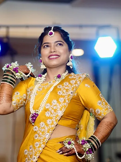 A vibrant Haldi look requires a hairstyle that is both beautiful and practical. I created a lovely half-up style that keeps the hair off the face while perfectly complementing the traditional floral jewelry worn for the ceremony.