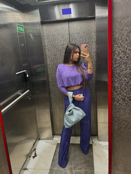 An elevator selfie of a monochrome purple co-ord set.