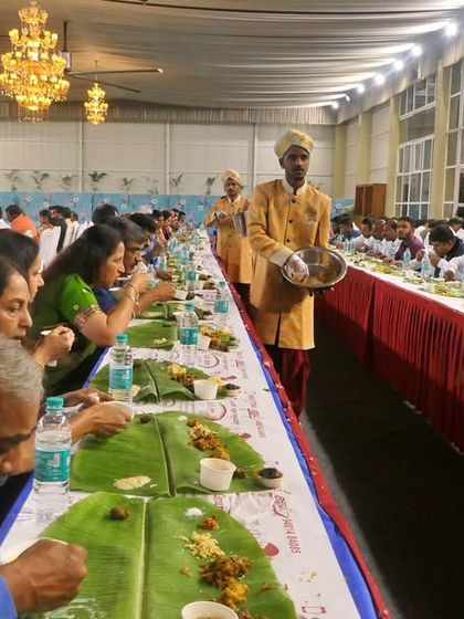 A long-shot view of the dining service. The coordinated effort of my team ensures that all guests seated in a long row are served in a timely manner.