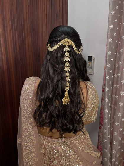 The back view of this gorgeous hairstyle, featuring a stunning traditional hair accessory. It’s the perfect finishing touch for an elegant engagement look.