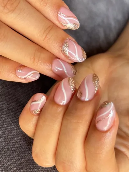 A sweet and swirly design in pink and white, with a touch of gold glitter for some sparkle. Perfect for short to medium length nails.