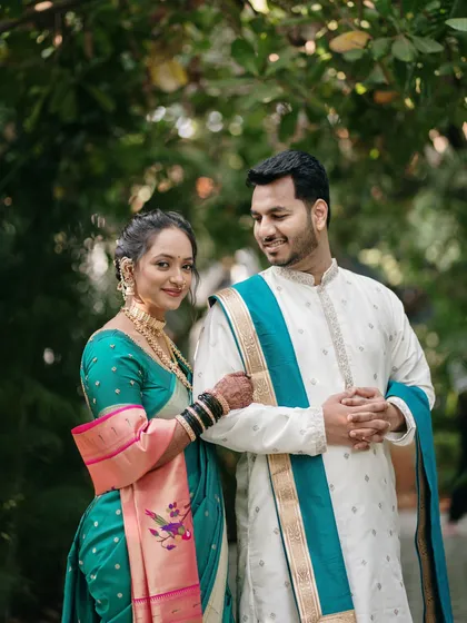 A classic pose that exudes elegance. The couple's gentle interaction and coordinated attire make for a stunning and timeless wedding portrait.
