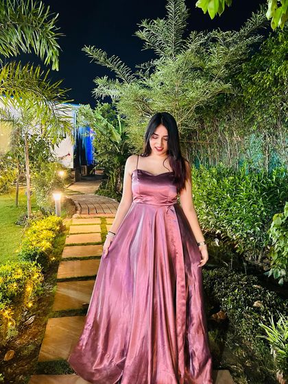 Walking through a garden in the mauve satin gown. I create a fairytale moment to show how the dress moves and feels, making it more than just an outfit.