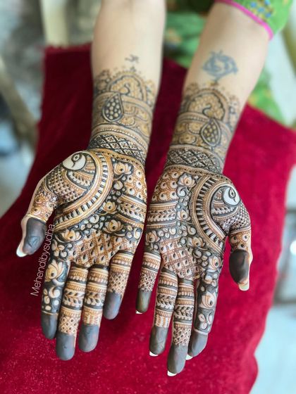 The design against a red background, which makes the henna details pop.