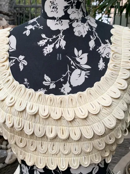A close-up of the handcrafted scalloped blouse. This can be paired with a saree, a skirt, or pants.
