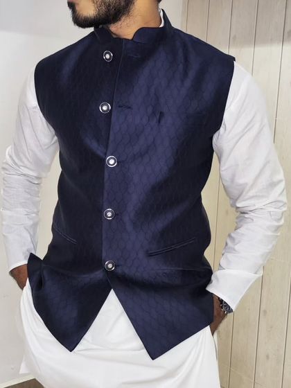 A close-up of the navy blue jacquard jacket, showing the texture of the fabric.