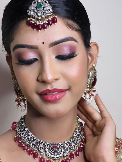 A beautiful shot highlighting the makeup and the intricate details of the jewellery. The ruby beads add a lovely pop of colour.
